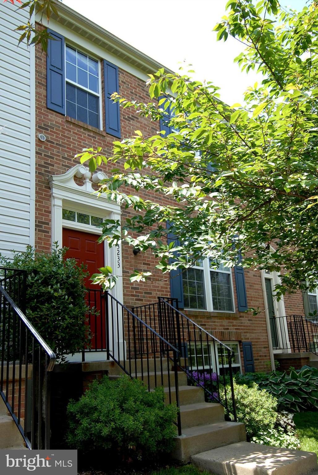 a front view of a house with plants and garden