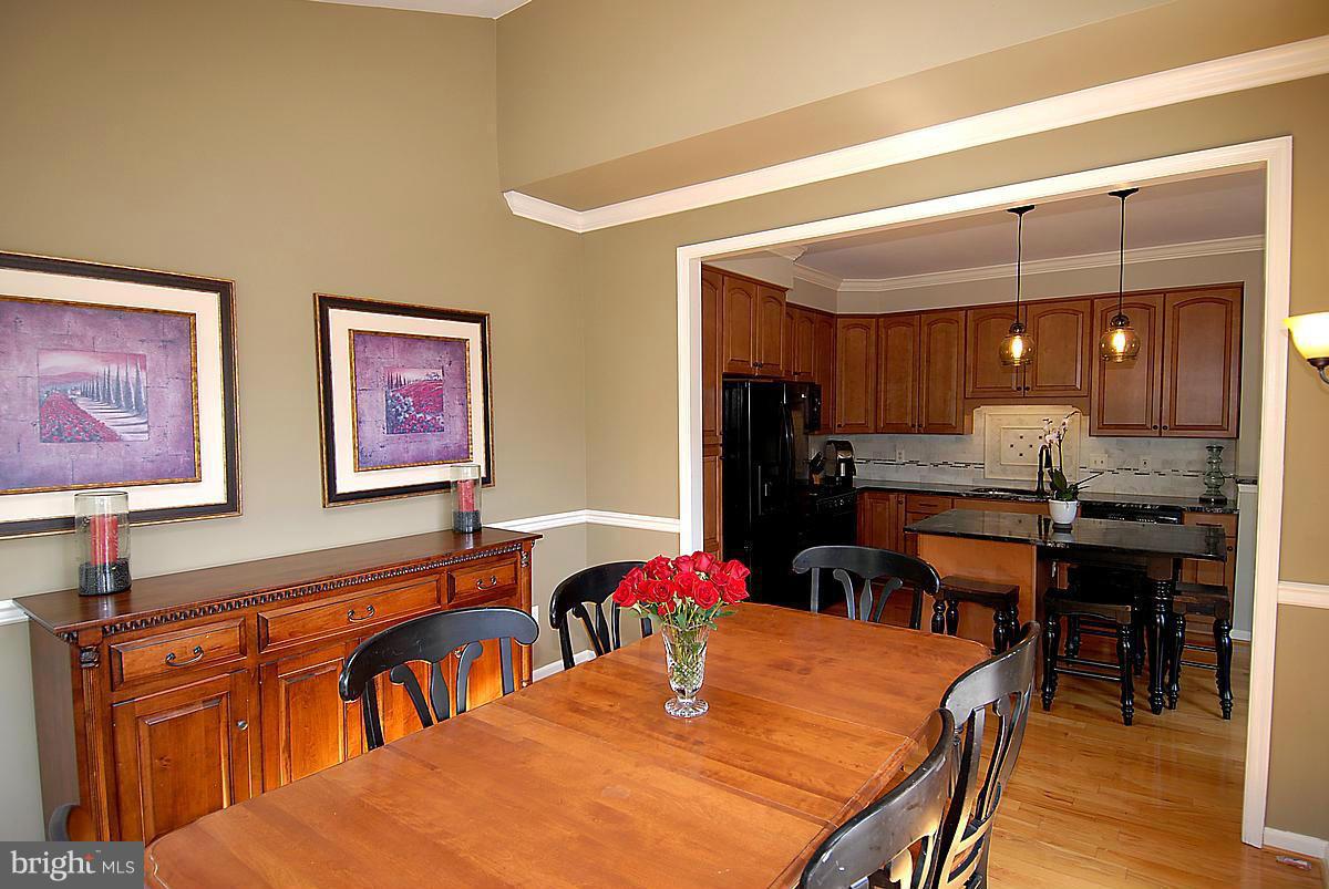 43233 Stillforest Terrace Ashburn, VA 20147 - Photo 13 of 30 a view of a dining room with furniture