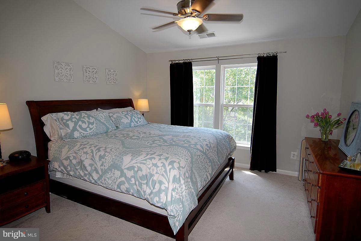 43233 Stillforest Terrace Ashburn, VA 20147 - Photo 16 of 30 a bed sitting in a bedroom next to a window