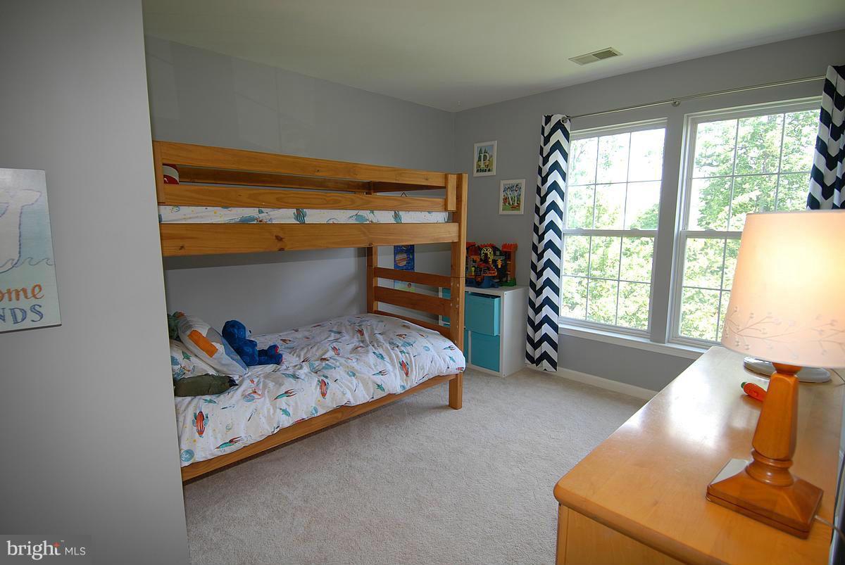 43233 Stillforest Terrace Ashburn, VA 20147 - Photo 22 of 30 a bed room with a bed and a window