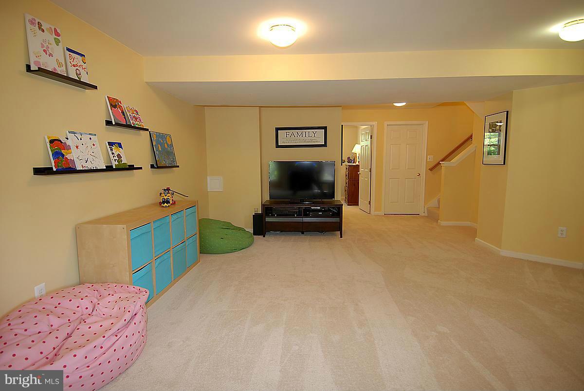 43233 Stillforest Terrace Ashburn, VA 20147 - Photo 25 of 30 a bedroom with a bed and a couch
