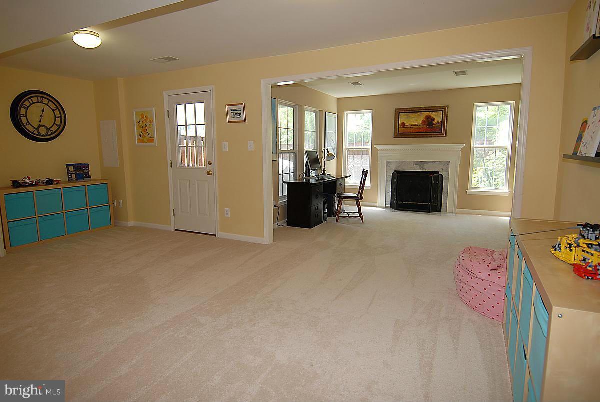 43233 Stillforest Terrace Ashburn, VA 20147 - Photo 26 of 30 a bed room with furniture and a fireplace