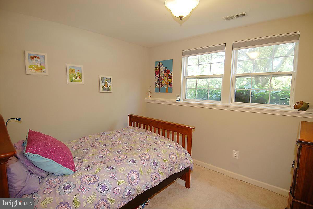 43233 Stillforest Terrace Ashburn, VA 20147 - Photo 29 of 30 a bedroom with a bed and a window
