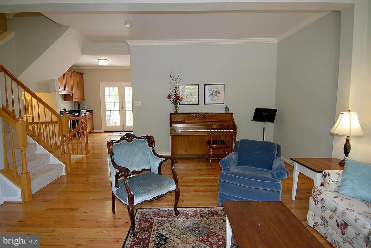 43233 Stillforest Terrace Ashburn, VA 20147 - Photo 5 of 30 a living room with furniture and a lamp