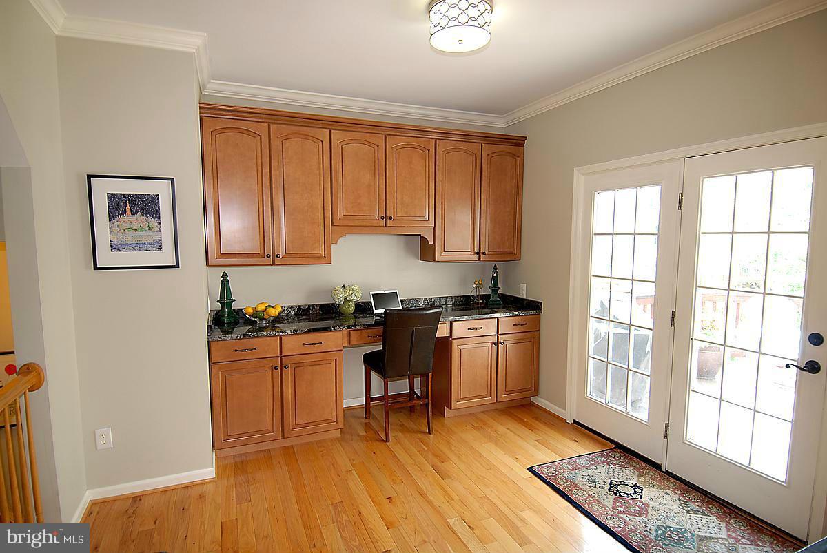 43233 Stillforest Terrace Ashburn, VA 20147 - Photo 8 of 30 a kitchen with a refrigerator and wooden cabinets
