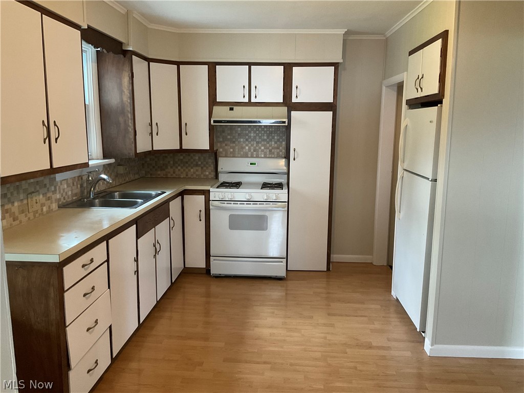 3475 South Turner Road Canfield, OH 44406 - Photo 13 of 33 Kitchen with white cabinets, white appliances, backsplash, and light wood-type flooring