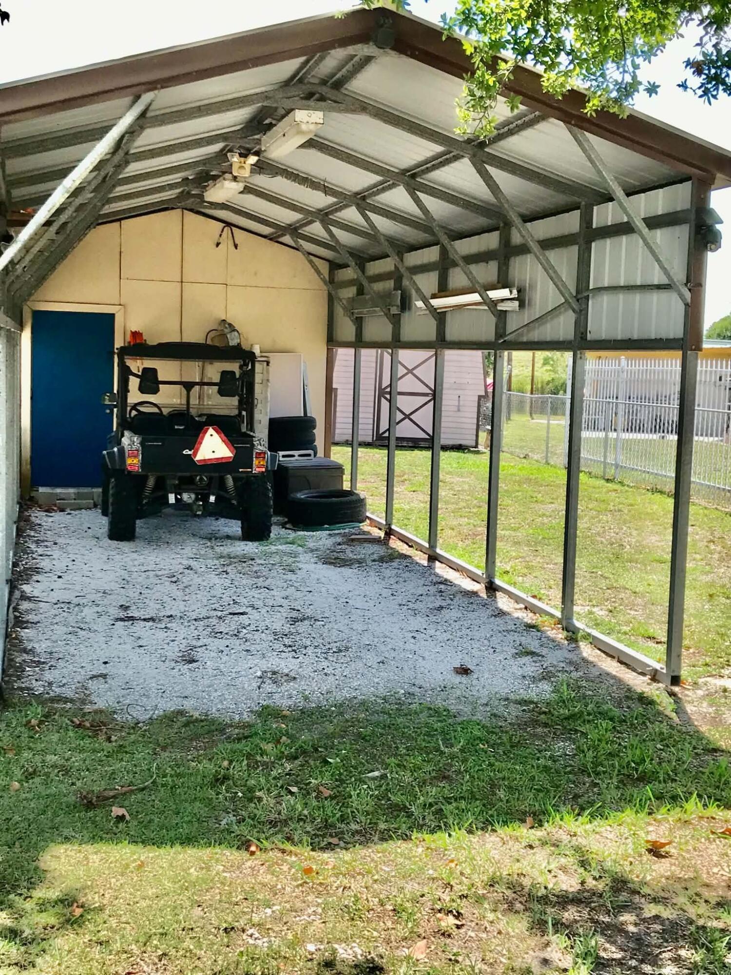 1115 Elm Street Okeechobee, FL 34974 - Photo 30 of 37 a view of a car is parked in a yard