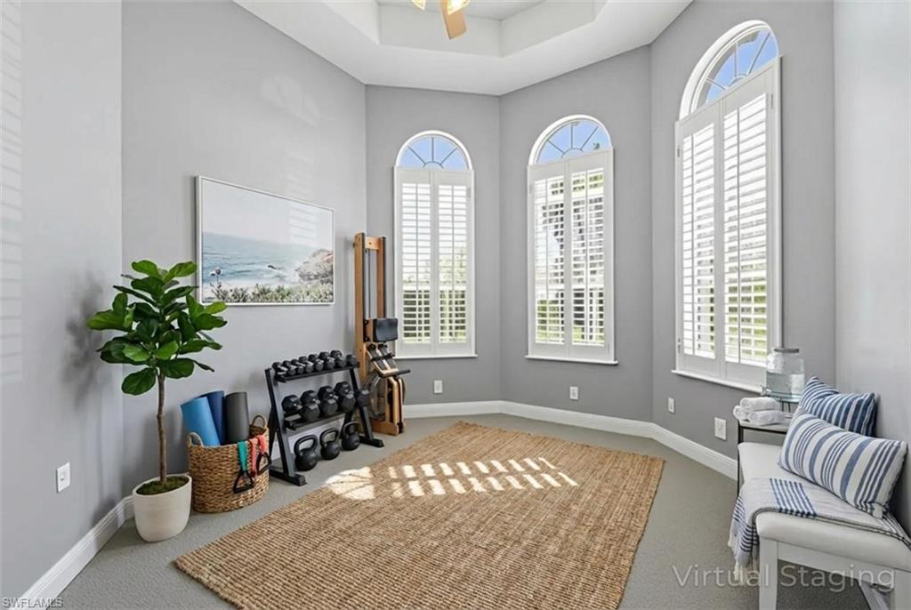 480 Terracina Way Naples, FL 34119 - Photo 12 of 40 Sitting room featuring carpet flooring and a tray ceiling