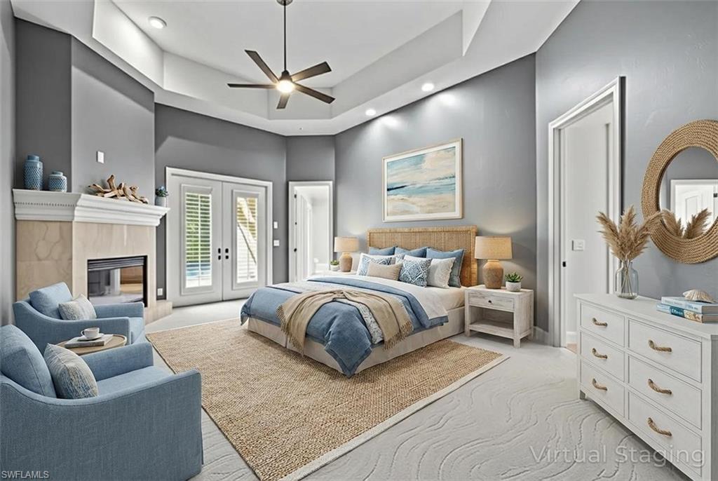 480 Terracina Way Naples, FL 34119 - Photo 13 of 40 Bedroom featuring light carpet, access to exterior, a tiled fireplace, a ceiling fan, and recessed lighting