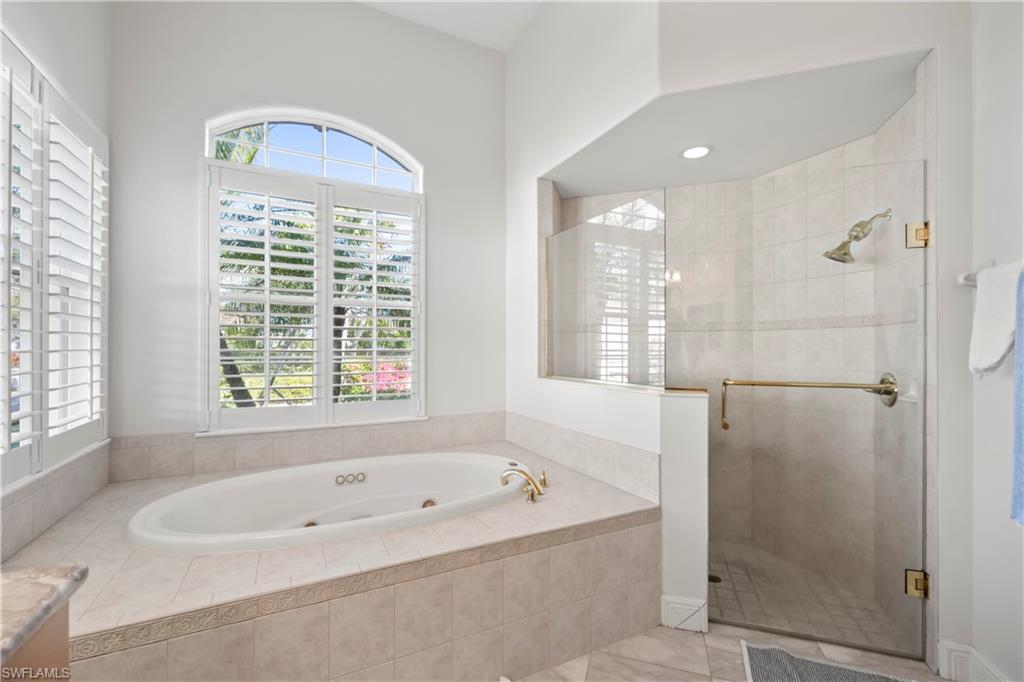 480 Terracina Way Naples, FL 34119 - Photo 16 of 40 Full bathroom with a jetted tub and a stall shower