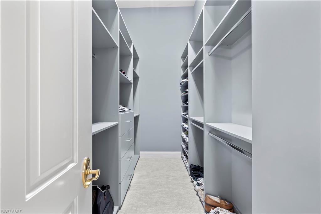 480 Terracina Way Naples, FL 34119 - Photo 19 of 40 Spacious closet featuring light colored carpet