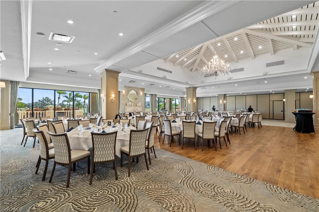 480 Terracina Way Naples, FL 34119 - Photo 33 of 40 Dining area with hardwood / wood-style floors, a chandelier, ornate columns, a tray ceiling, and recessed lighting