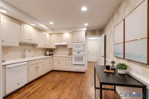 a kitchen with white cabinets and counter space