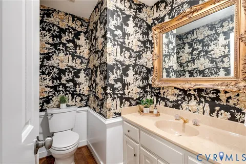 a bathroom with a sink toilet and a mirror