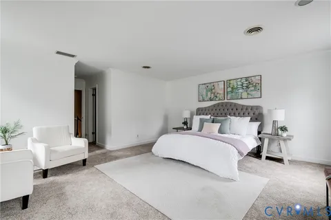 a bedroom with a bed and a couch