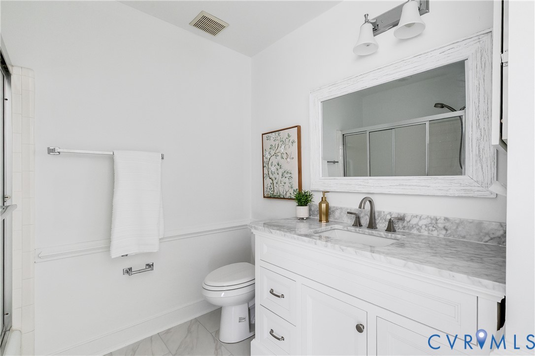 8902 Ginger Way Court Henrico, VA 23229 - Photo 25 of 34 a bathroom with a granite countertop sink vanity mirror and toilet