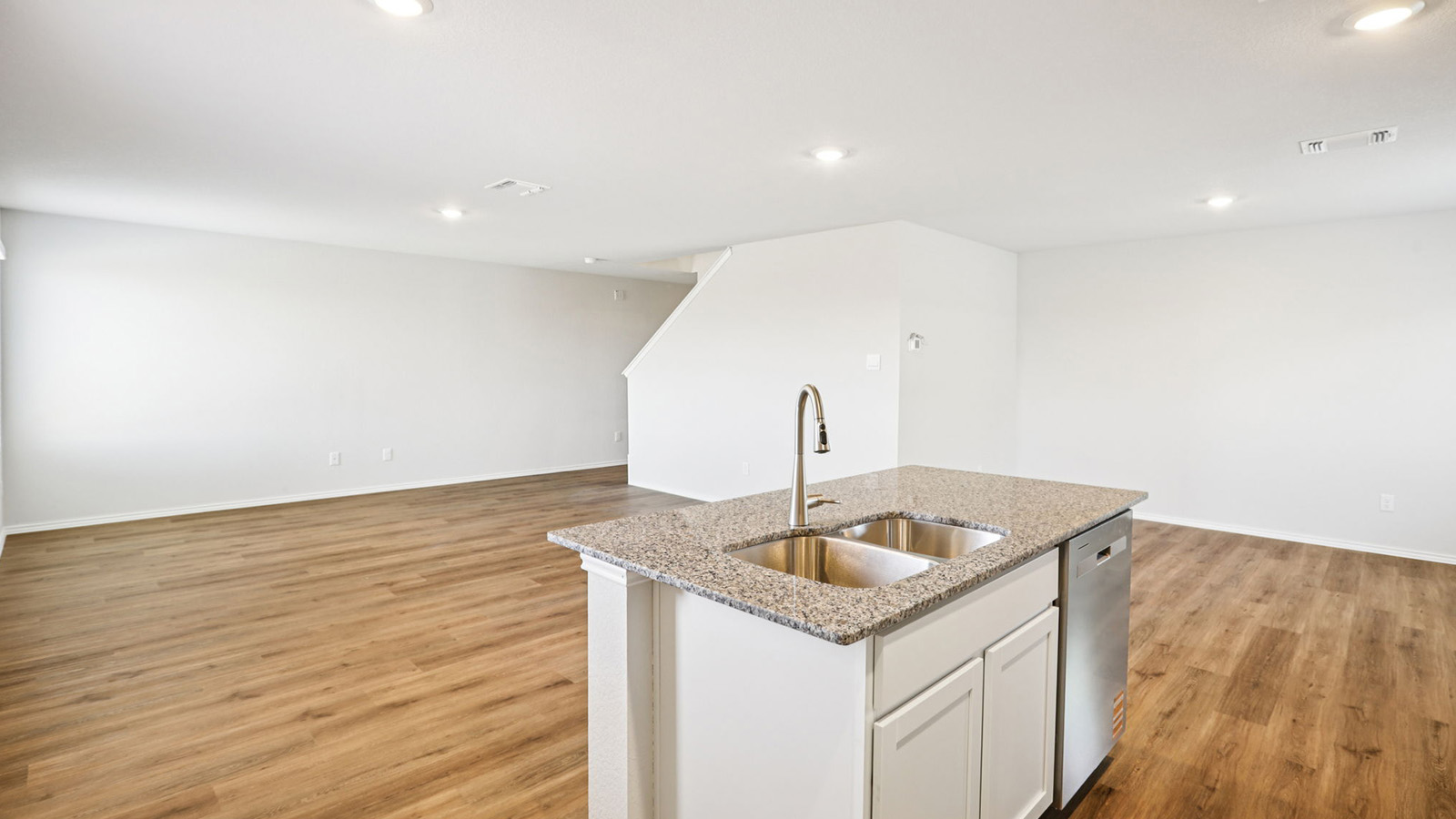 133 Wyatt Way Jarrell, TX 76537 - Photo 6 of 32 Kitchen island featuring a stainless steel double basin sink, high-arc faucet, and granite countertop