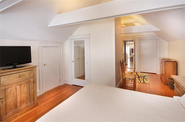 5 Marshall Road Winchester, MA 01890 - Photo 17 of 22 a bedroom with a bed and a flat screen tv