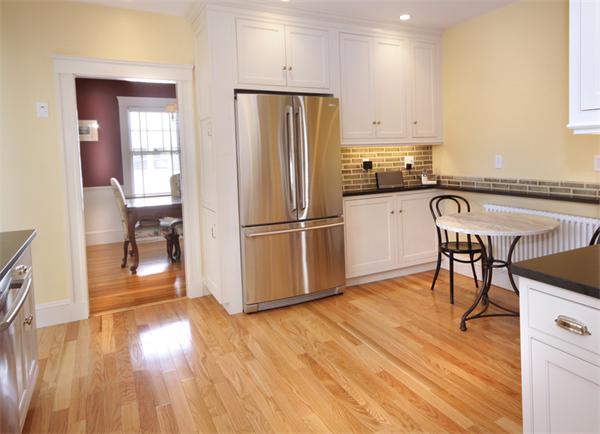 5 Marshall Road Winchester, MA 01890 - Photo 9 of 22 a kitchen with granite countertop wooden floors and stainless steel appliances