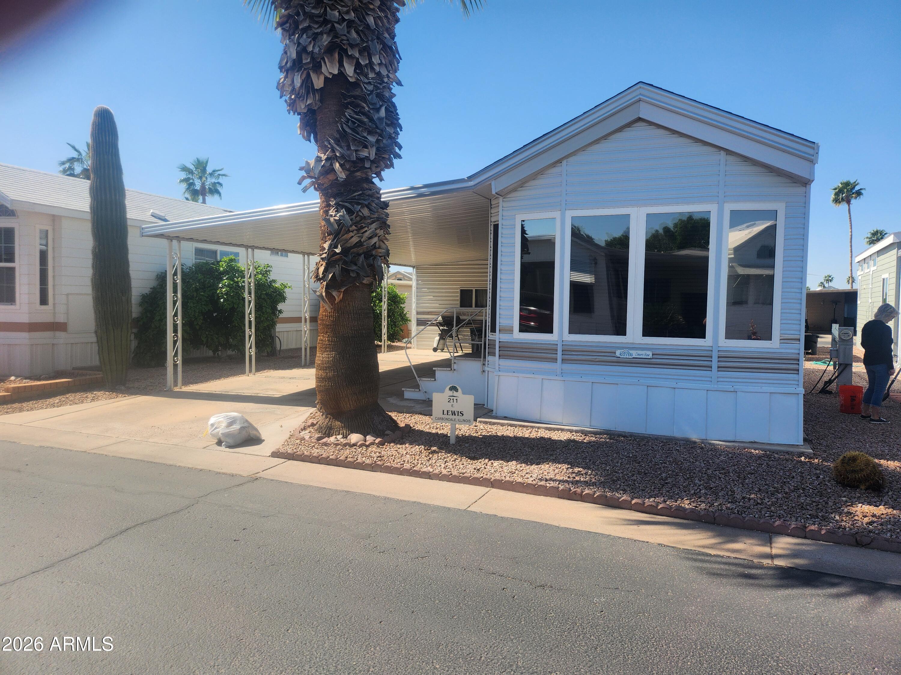 111 South Greenfield Road, Unit 211 Mesa, AZ 85206 - Photo 1 of 6 a front view of a house with garden