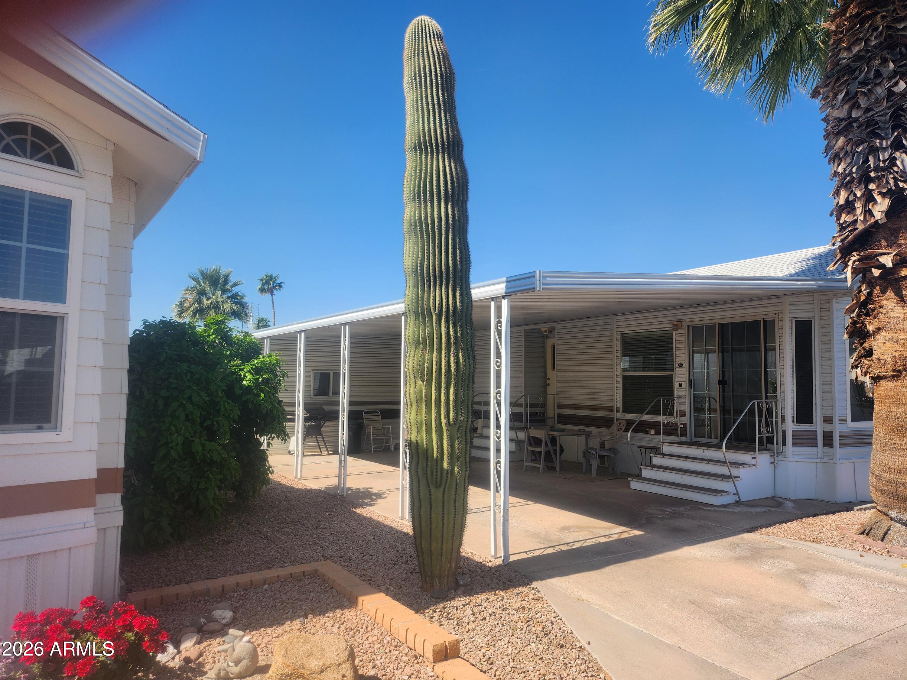 111 South Greenfield Road, Unit 211 Mesa, AZ 85206 - Photo 2 of 6 a view of a patio with table and chairs potted plants