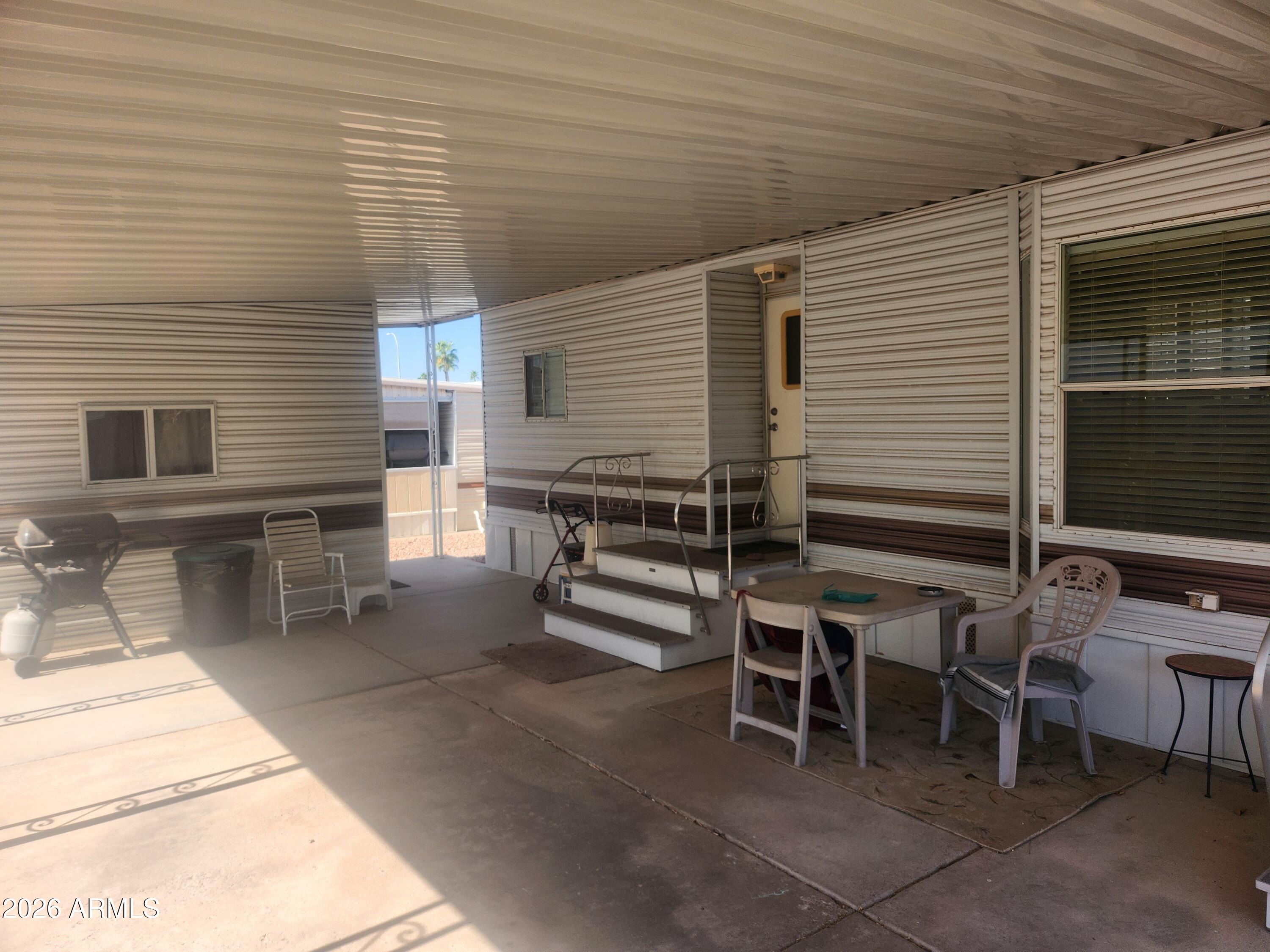 111 South Greenfield Road, Unit 211 Mesa, AZ 85206 - Photo 3 of 6 a view of a patio with table and chairs and couches