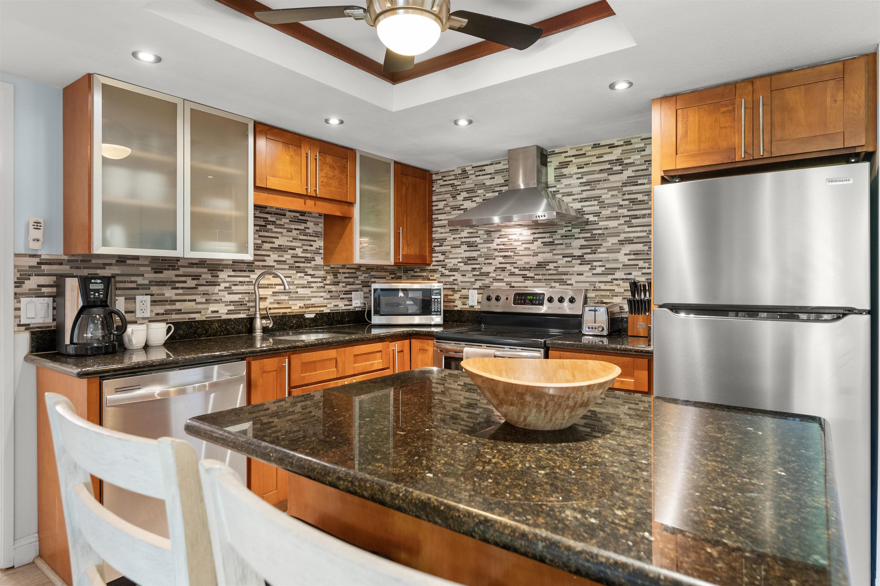 2575 South Kihei Road, Unit T110 Kihei, HI 96753 - Photo 13 of 24 a kitchen with stainless steel appliances granite countertop a sink a stove and a refrigerator