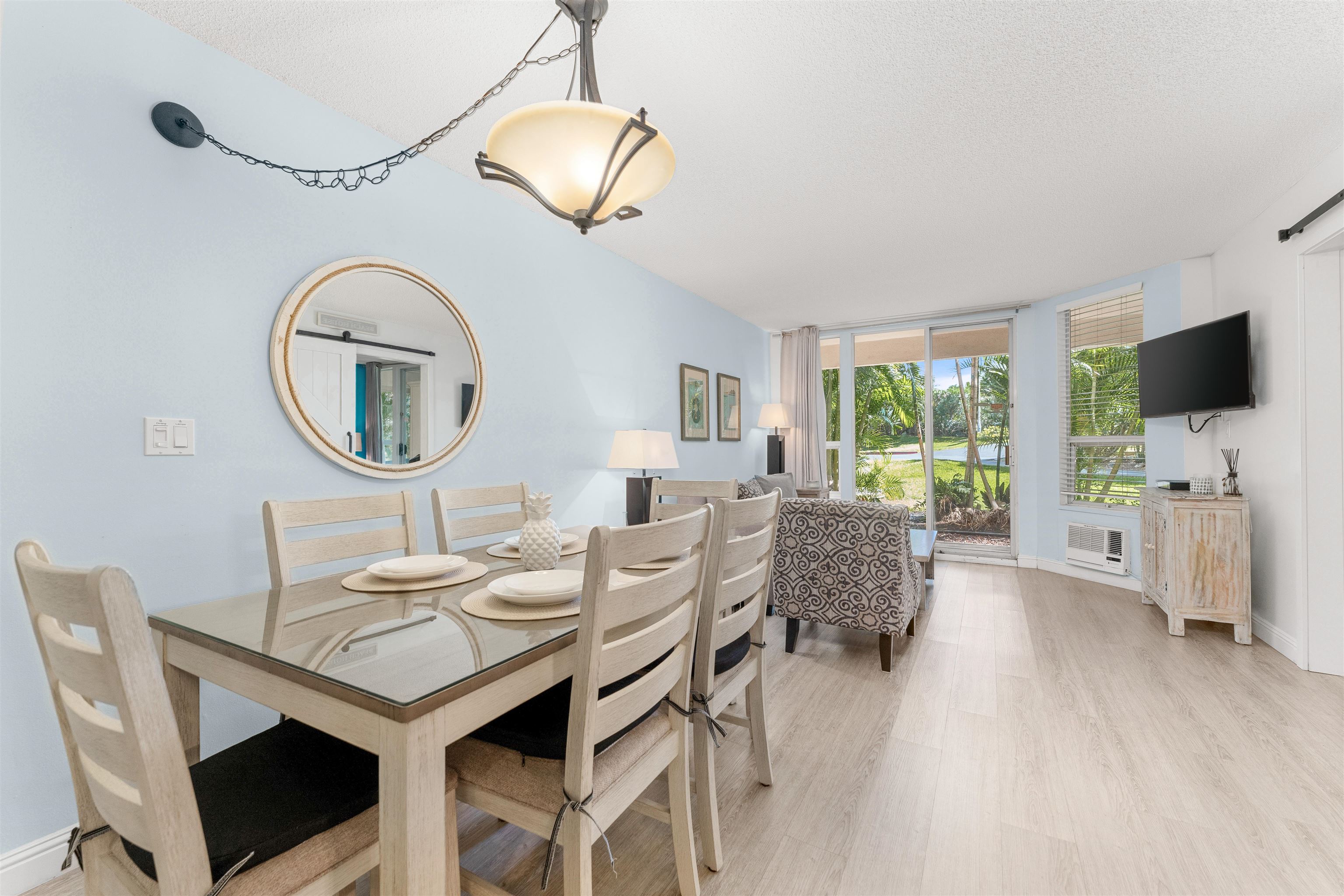 2575 South Kihei Road, Unit T110 Kihei, HI 96753 - Photo 14 of 24 a dining room with furniture a mirror and wooden floor