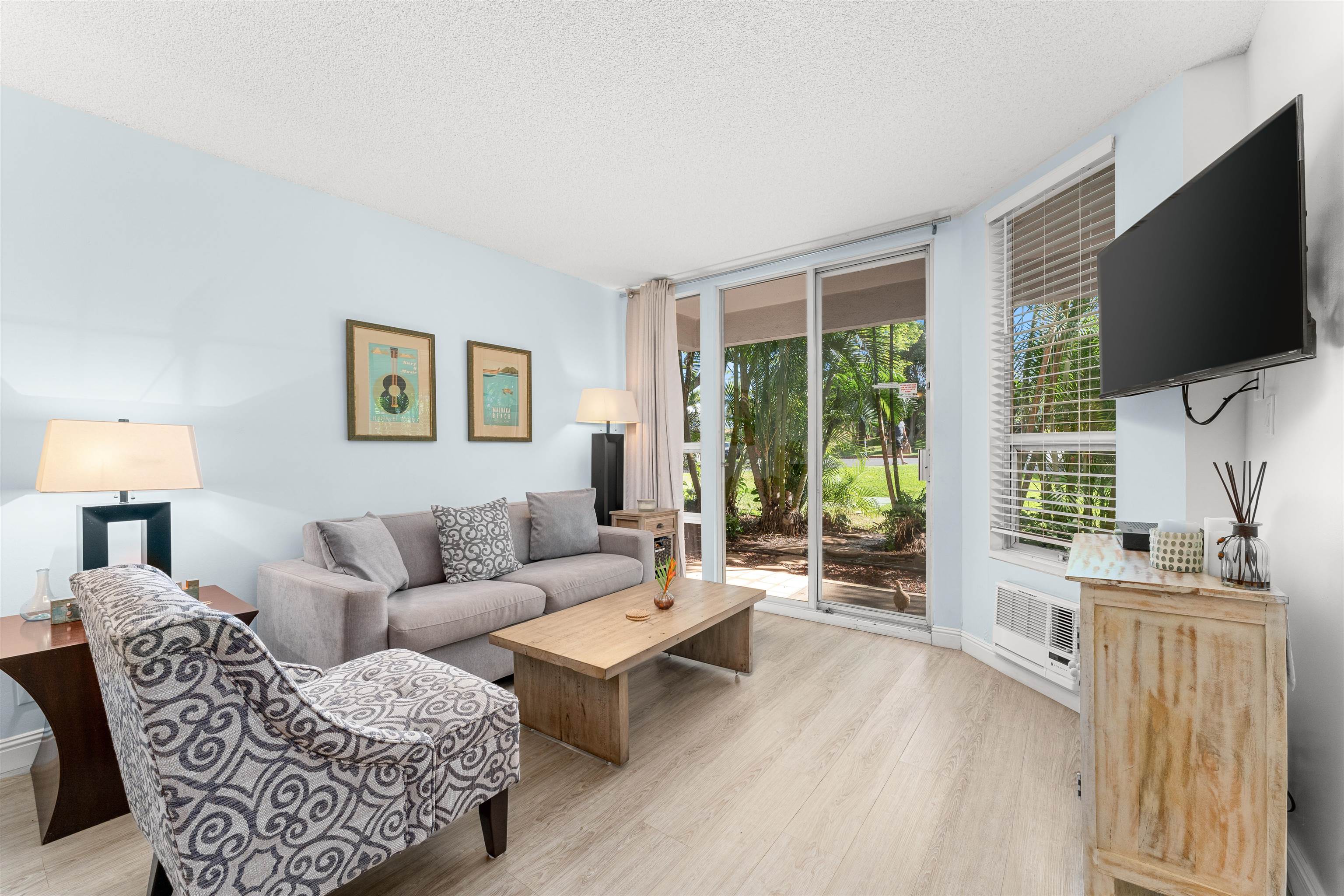 2575 South Kihei Road, Unit T110 Kihei, HI 96753 - Photo 15 of 24 a living room with furniture a flat screen tv and a large window
