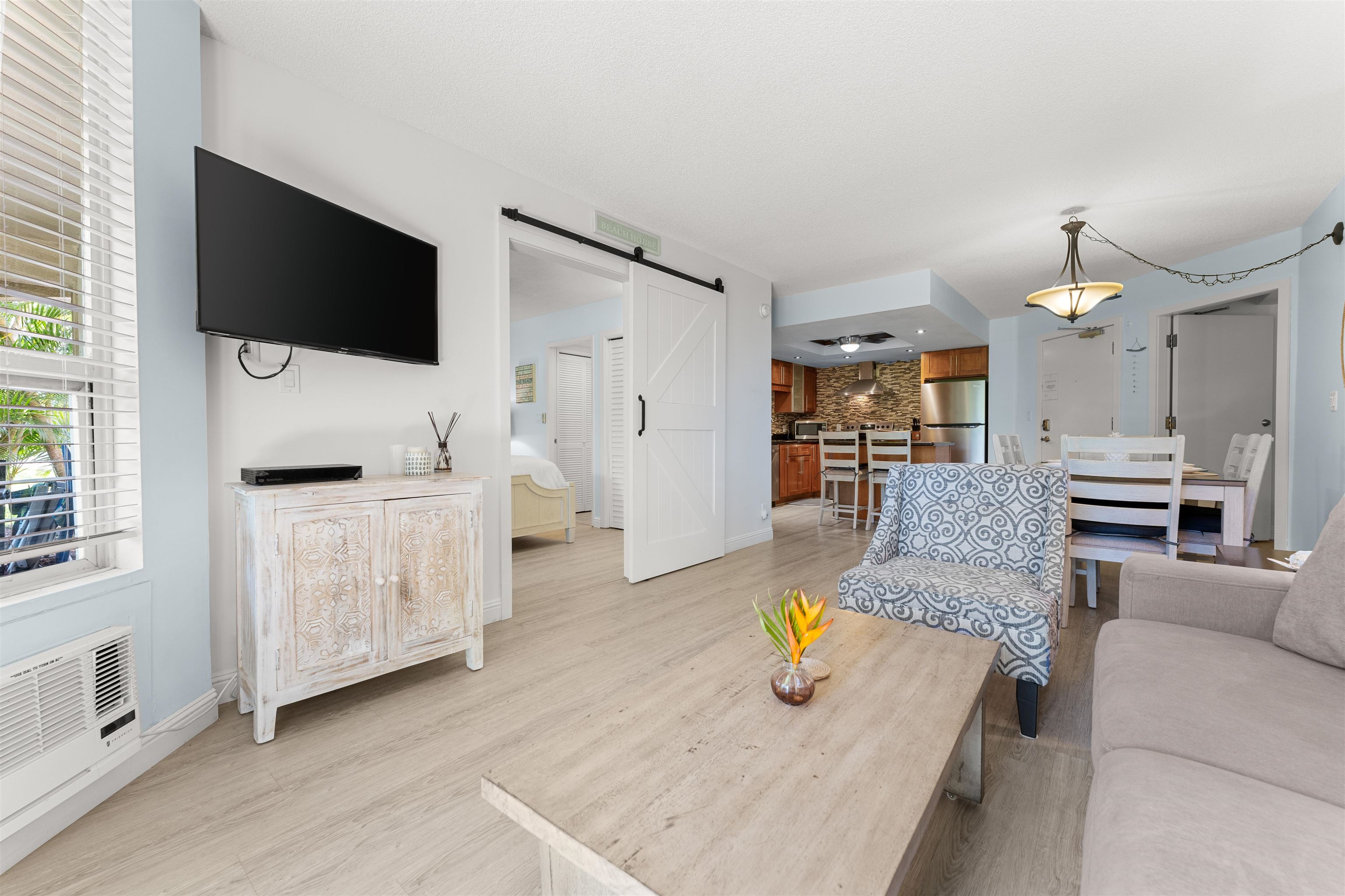 2575 South Kihei Road, Unit T110 Kihei, HI 96753 - Photo 4 of 24 a living room with furniture and a flat screen tv