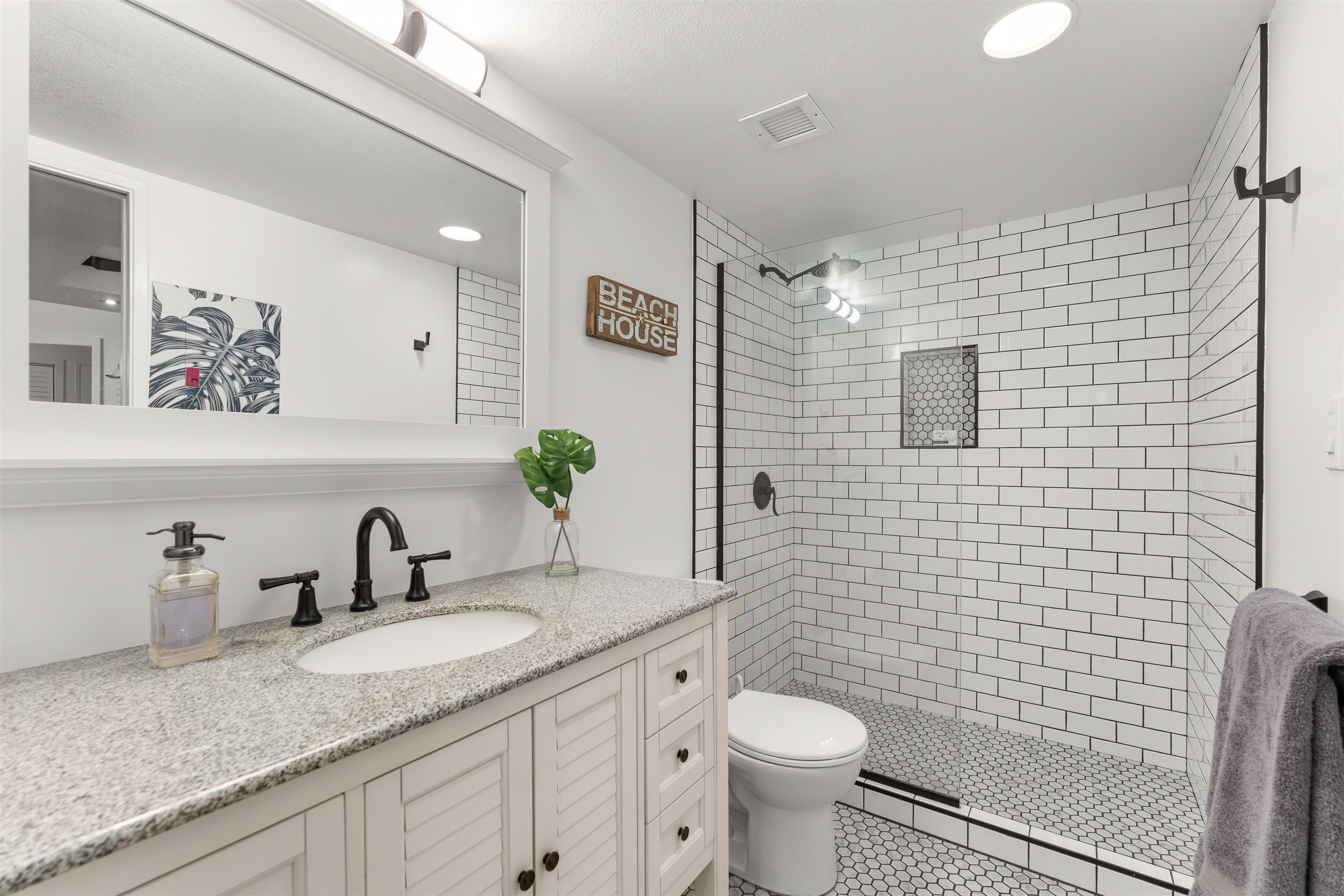 2575 South Kihei Road, Unit T110 Kihei, HI 96753 - Photo 8 of 24 a bathroom with a granite countertop toilet sink and mirror