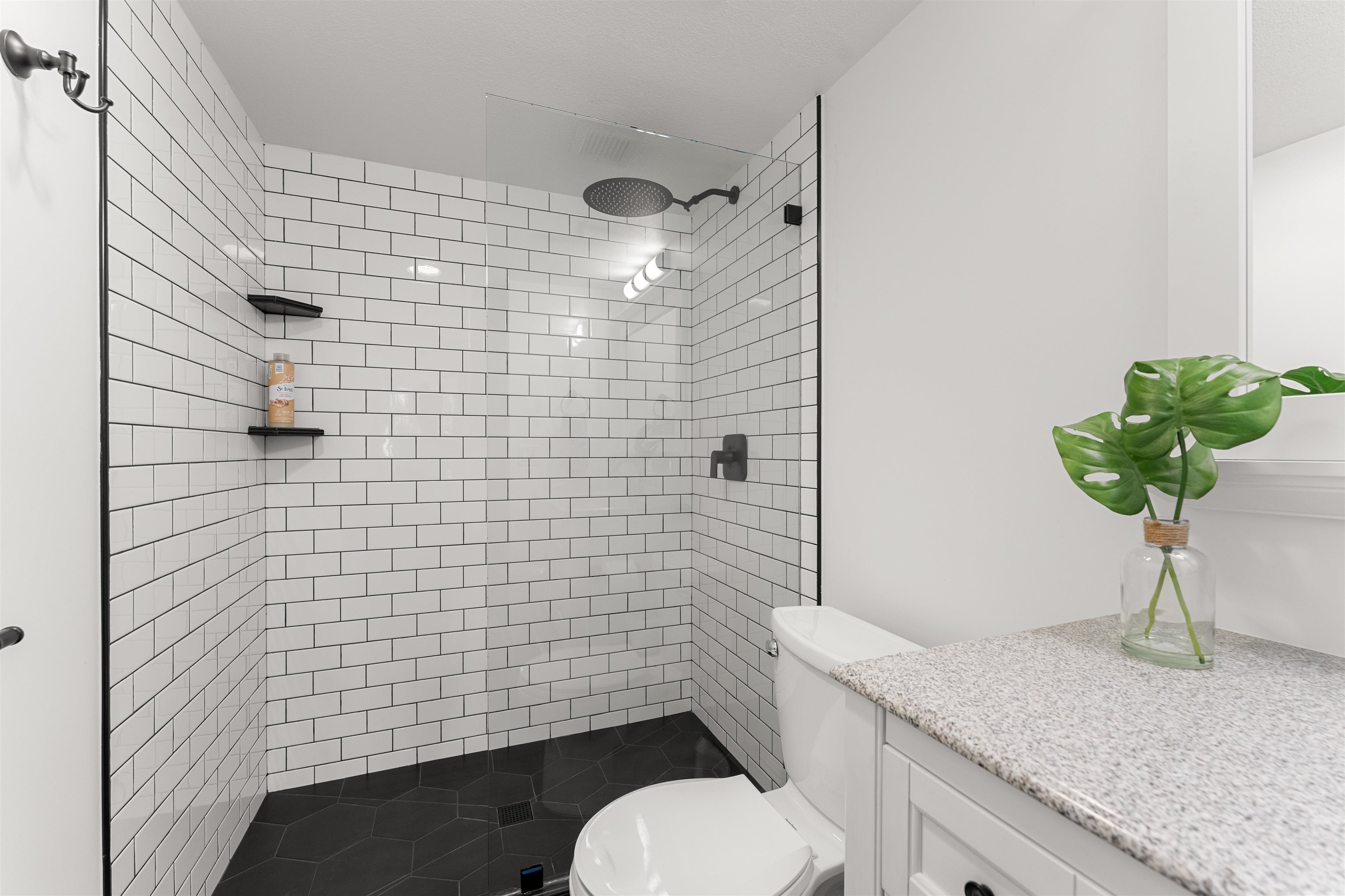 2575 South Kihei Road, Unit T110 Kihei, HI 96753 - Photo 10 of 24 a bathroom with a granite countertop toilet a sink and mirror