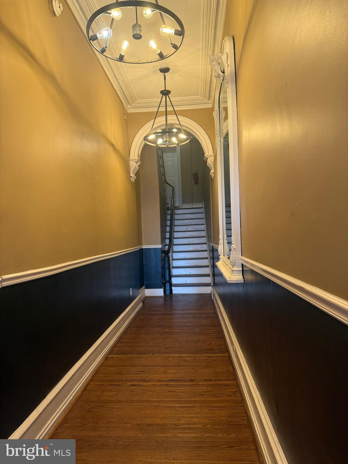 1602 Spruce Street, Unit 2R Philadelphia, PA 19103 - Photo 3 of 11 a view of a room with wooden floor and staircase