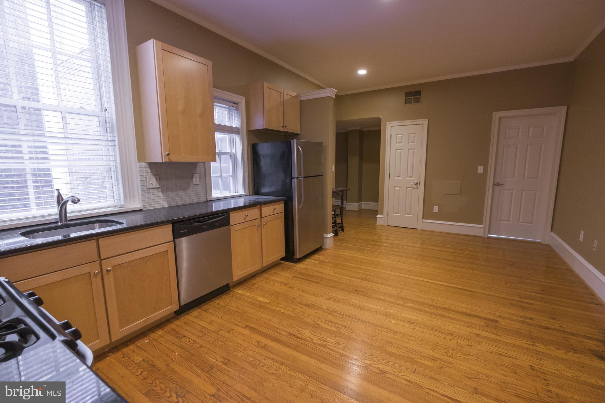 1602 Spruce Street, Unit 2R Philadelphia, PA 19103 - Photo 4 of 11 a kitchen with stainless steel appliances granite countertop a sink and cabinets
