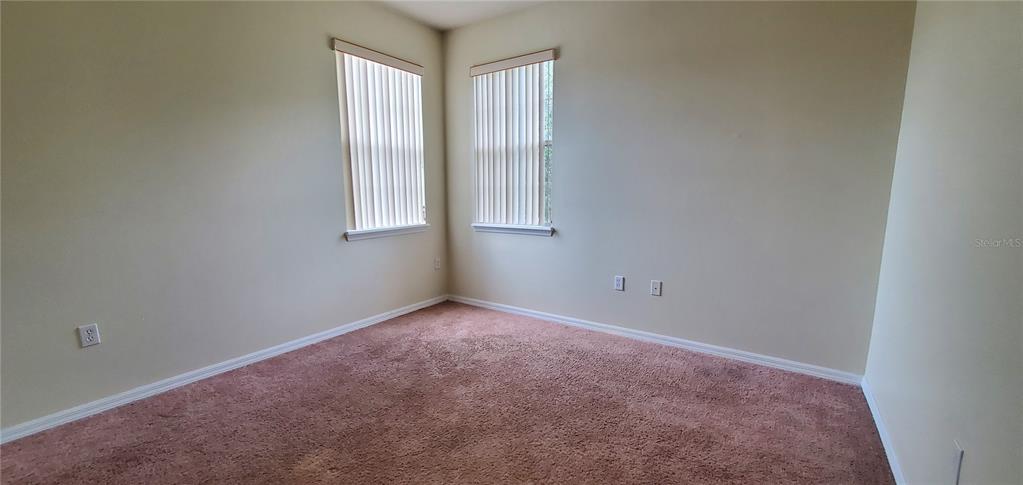 356 Monroe Circle Davenport, FL 33896 - Photo 6 of 9 an empty room with windows
