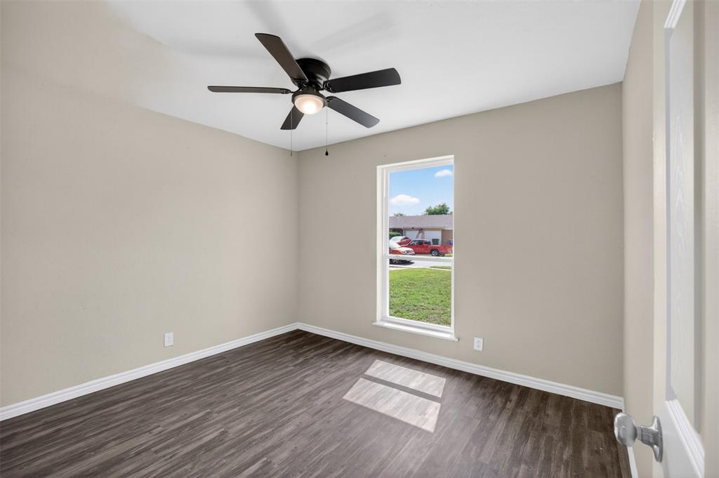 7528 Meadowlark Lane North Watauga, TX 76148 - Photo 17 of 31 wooden floor in an empty room with a window
