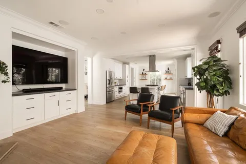a living room with furniture fireplace and flat screen tv