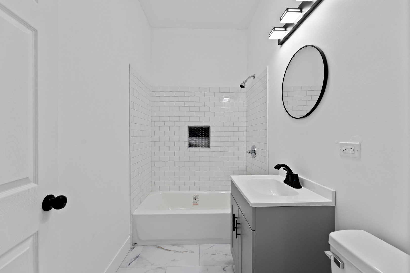 1421 East 69th Place Chicago, IL 60637 - Photo 11 of 14 a bathroom with a sink a toilet and a mirror