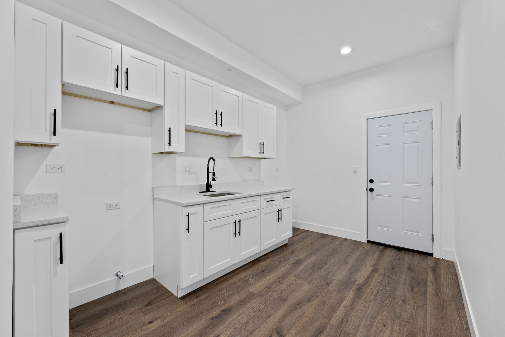 1421 East 69th Place Chicago, IL 60637 - Photo 12 of 14 a kitchen with cabinets wooden floor and a sink