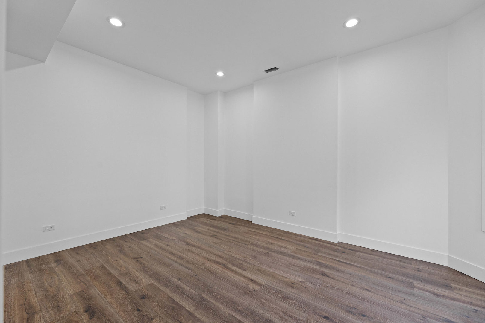 1421 East 69th Place Chicago, IL 60637 - Photo 3 of 14 a view of room with wooden floor and white walls