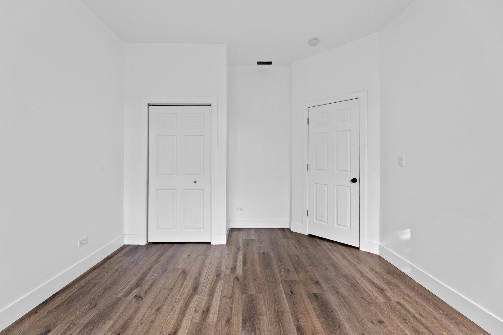 1421 East 69th Place Chicago, IL 60637 - Photo 8 of 14 a view of an empty room with wooden floor