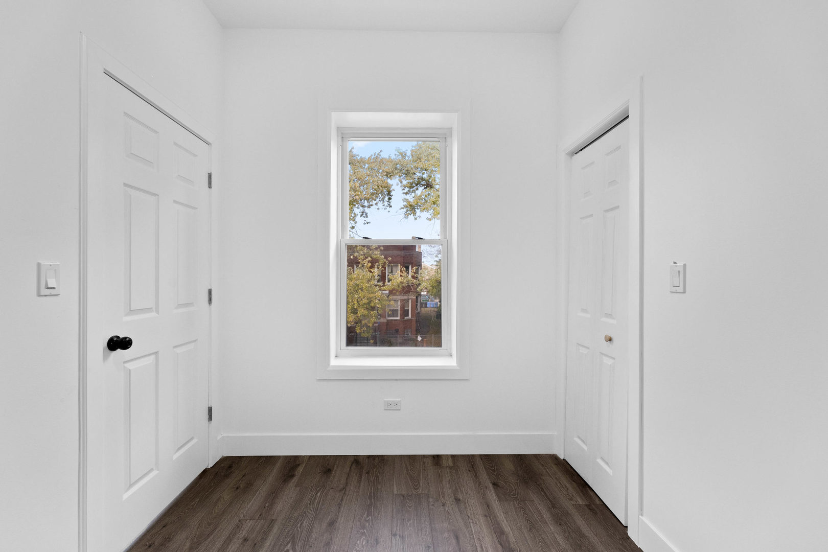 1421 East 69th Place Chicago, IL 60637 - Photo 9 of 14 an empty room with wooden floor and windows