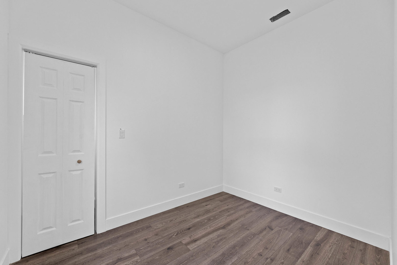 1421 East 69th Place Chicago, IL 60637 - Photo 10 of 14 a view of an empty room with wooden floor