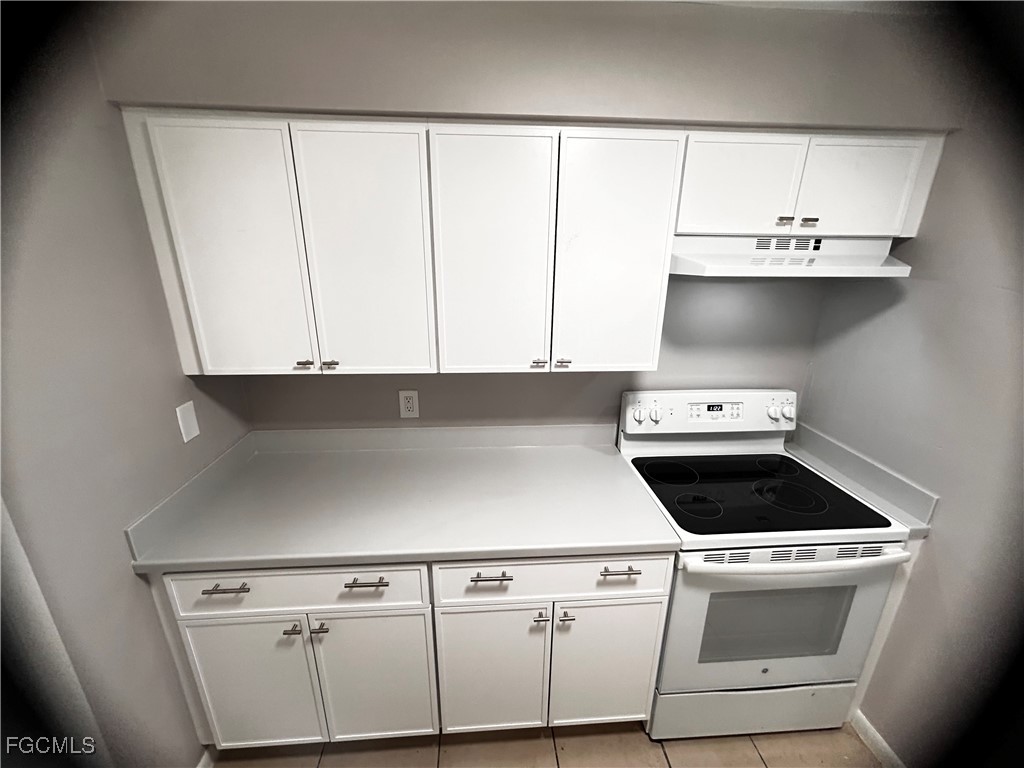 18592 Matanzas Road Fort Myers, FL 33967 - Photo 11 of 25 a kitchen with white cabinets and white appliances