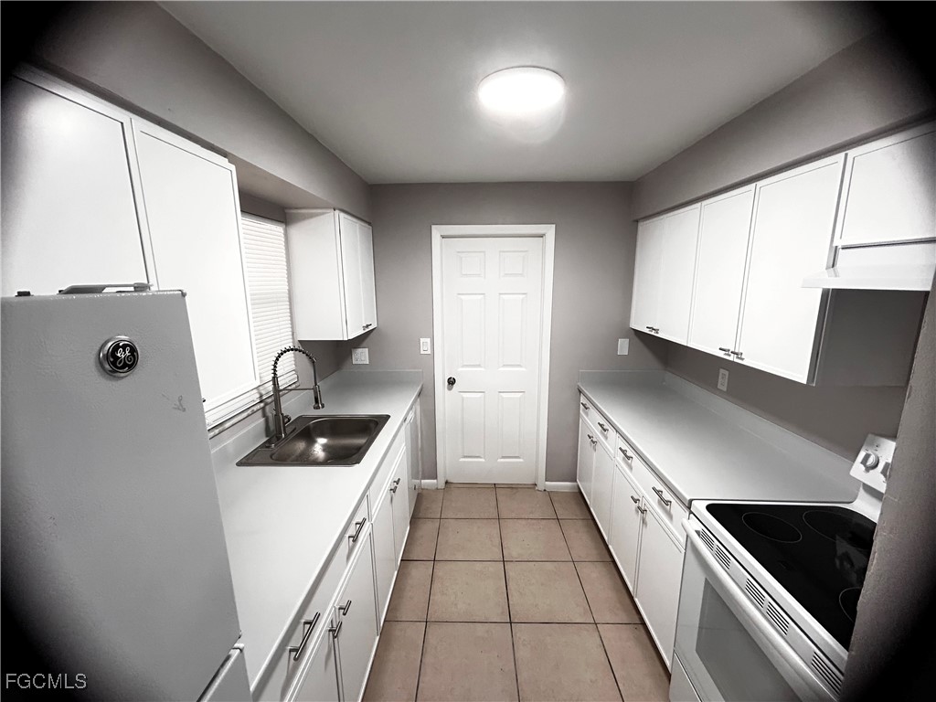 18592 Matanzas Road Fort Myers, FL 33967 - Photo 13 of 25 a kitchen with granite countertop a stove sink and cabinets