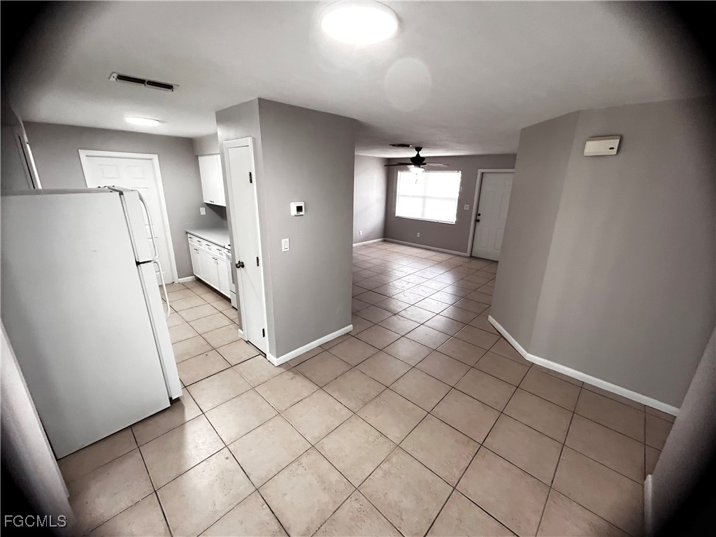 18592 Matanzas Road Fort Myers, FL 33967 - Photo 18 of 25 a view of a refrigerator in kitchen and wooden floor