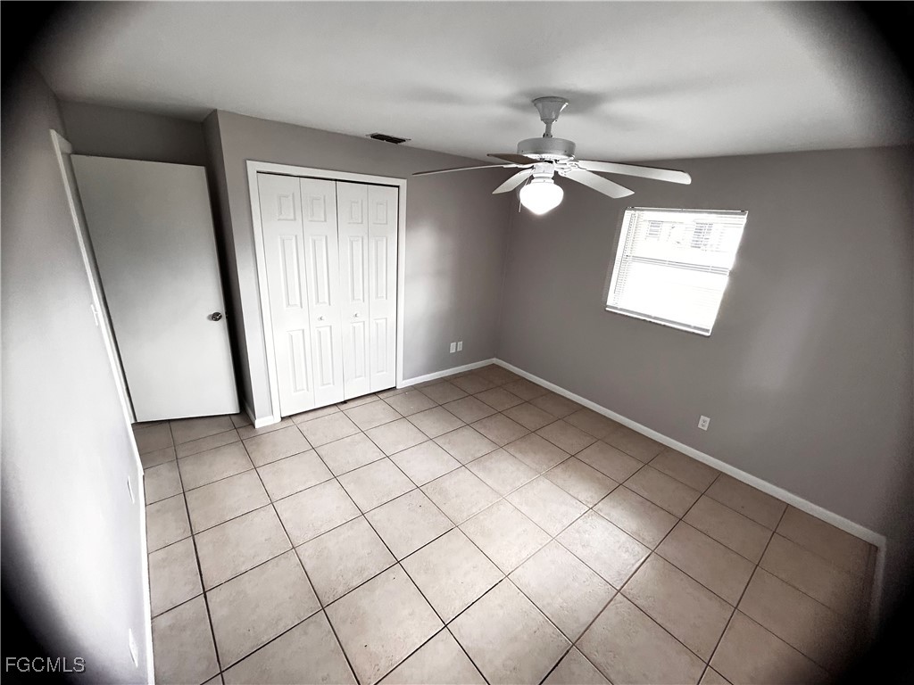 18592 Matanzas Road Fort Myers, FL 33967 - Photo 23 of 25 an empty room with windows and fan