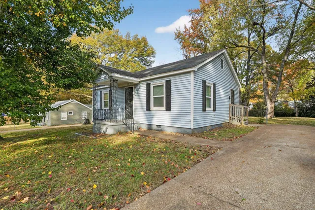 a front view of house with yard and trees