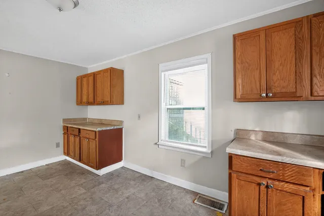 a kitchen with stainless steel appliances granite countertop a stove a sink a refrigerator and wooden cabinets