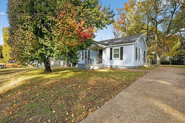 a front view of house with yard and trees